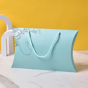 Light blue pillow gift box detail view, elegant paper packaging box with handle rope.