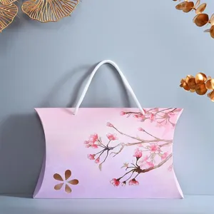 Elegant purple pink cherry blossom pillow gift box with white handle for seasonal gift packaging.