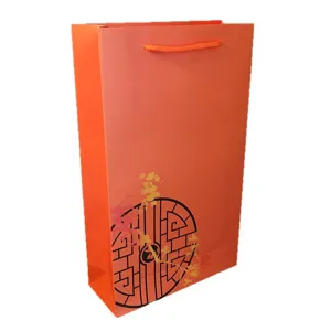 Orange paper gift bag with rope handle and traditional Chinese blossom window graphic for packing.