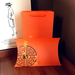 Orange paper gift bag and pillow box set for clothing, scarves, and accessories packaging.