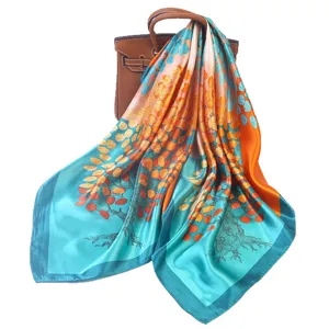 Luxurious 90x90cm silk square scarf featuring vibrant autumn tree print, smooth satin finish.