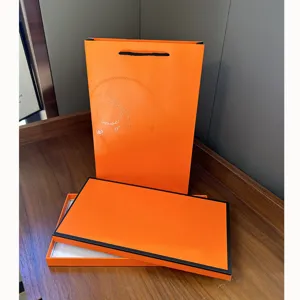 Premium orange gift box and bag set, luxury style packaging for silk scarves and apparel.