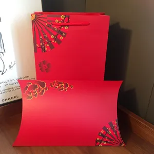 Red paper gift bag and pillow box set with Chinese fan and plum blossom design for holidays.