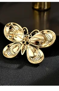 Gold butterfly brooch back detail shot, showing pin mechanism and crystal rhinestone pavé.