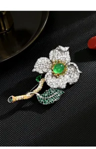 Detailed view of a stunning green flower brooch, sparkling cubic zirconia, elegant clothing accessory.