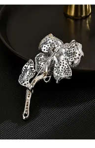 Detailed view of exquisite flower brooch back showing pin structure and sparkling cubic zirconia.