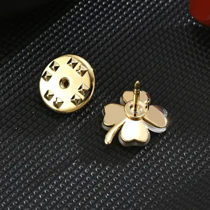 Gold four leaf clover lapel pin, elegant cat eye brooch for women, cute anti glare clothing accessory.