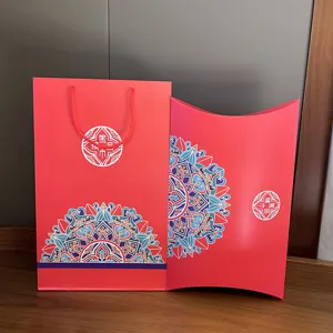Red paper gift bag and pillow box set with intricate mandala patterns for festive packaging