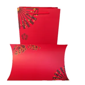 Red gift box and paper bag set for scarf and apparel packaging with traditional fan floral design.