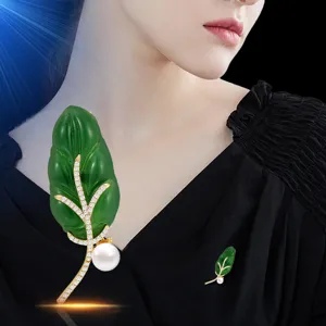 Elegant green leaf brooch with pearls and crystals, perfect for women's winter coats.