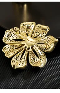 Gold tone floral brooch pin back detail shot showcasing intricate metalwork and secure clasp.