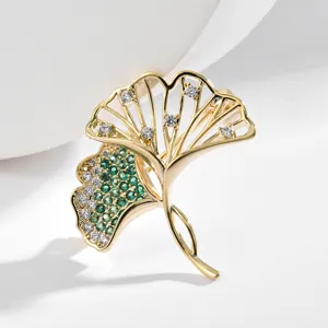 Elegant gold-plated double ginkgo leaf brooch featuring green and white zirconia. Perfect gift.