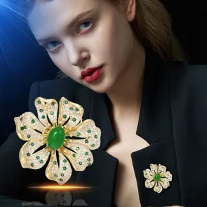 Elegant European design flower brooch with green stone and sparkling diamonte accents coat.