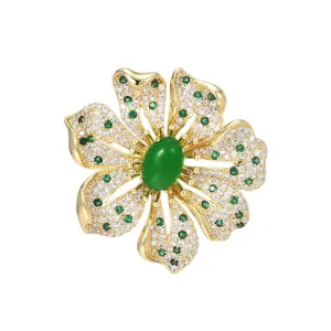 Elegant European design flower brooch with green center stone and sparkling crystals for coat.
