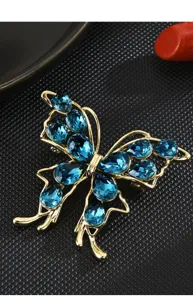 Exquisite blue crystal butterfly brooch close-up, featuring sparkling zircon and gold frame.