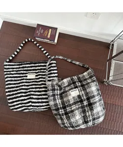 Detailed texture view of cozy retro striped and plaid fleece shoulder tote bags