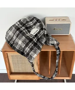 Vintage plaid fuzzy tote bag detail showing soft texture on a wooden cabinet