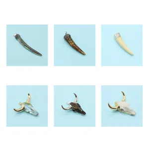 Detailed view of resin and acrylic bull horn and skull pendant charms for DIY jewelry making.