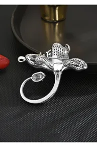 Detailed view of the back safety pin and pave cubic zirconia flower brooch structure.