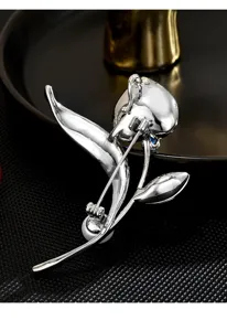 Exquisite silver metal tulip brooch detail shot featuring blue crystal and pearl accents.