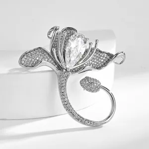 Stunning silver lily brooch sparkling with cubic zirconia and a gorgeous pear crystal pin accessory.