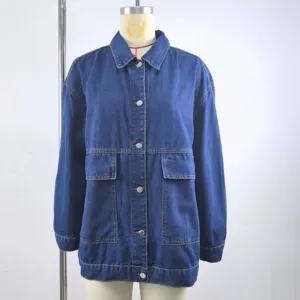 Detail view of a vintage style loose blue denim jacket featuring large functional front pockets