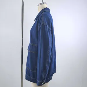 Side view showing the fit of a vintage loose blue denim jacket with functional pockets