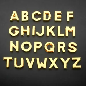 Close-up of 10mm golden alphabet charms A-Z for DIY jewelry accessories and straps
