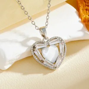 Exquisite silver-tone heart pendant necklace with shimmering cubic zirconia and white center stone.