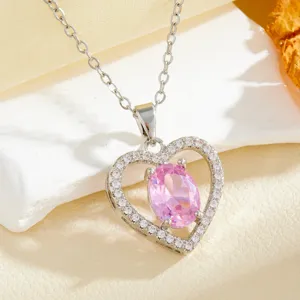 Heart-shaped pendant necklace featuring a pink oval zircon and sparkling micro-set clear stones.