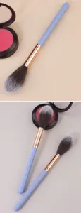 Close-up of flame-shaped makeup brush with soft bristles and blue handle for blush