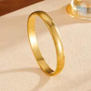 Elegant gold tone plain metal bangle bracelet, minimalist stainless steel fashion jewelry for women.