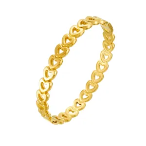 Close-up detail of the elegant hollow heart stainless steel gold plated bangle bracelet.