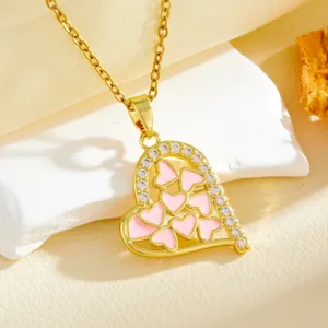 Gold heart pendant necklace with pink enamel and cubic zirconia details for women's fashion.