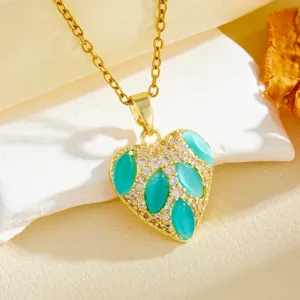 Gold heart necklace with turquoise marquise stones and sparkling clear zirconia crystals.