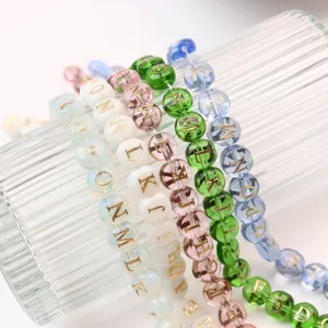 Colorful glass letter beads with gold foil print, perfect for DIY jewelry making and custom bracelets.