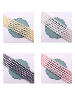 Detailed close-up view of colorful pearl imitation glass beads strands for DIY jewelry making.