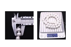 Detailed shot of white pearl beads showing diameter measurement with caliper and weight on scale.