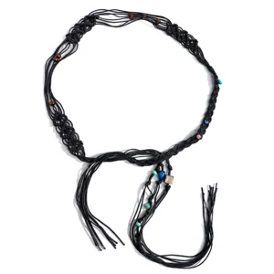 Close-up of bohemian black braided rope belt with colorful beads and tassel details for dress.