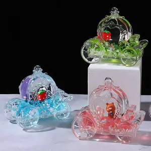 Detailed view of clear acrylic liquid quicksand pumpkin carriage ornament with cute desktop decor.