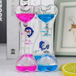 Clessidra liquida doppio cuore decorazione scrivania con gocce d'olio colorate e delfini.