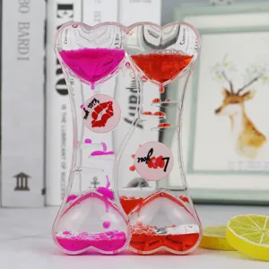 Double heart liquid motion bubbler hourglass desktop timer oil drop decoration close up detail