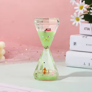 Detailed shot of green liquid oil hourglass ornament with glittering stars and micro decor.