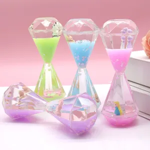 Detailed view of clear diamond liquid hourglass timer with cute miniature figures inside.