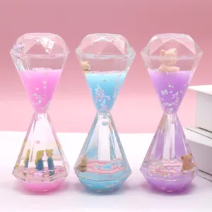 Clear liquid diamond hourglass oil drop timer with cute miniature figures and glitter.