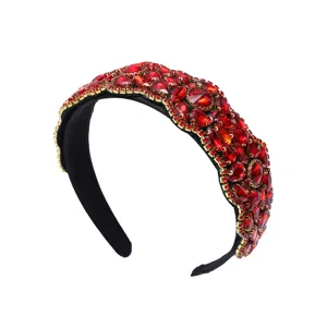 Detailed close-up of the luxury red crystal jeweled baroque headband, exquisite craftsmanship.