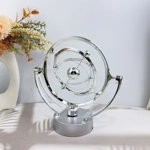 Detailed view of silver celestial perpetual motion machine, creative metal desk decor for home.