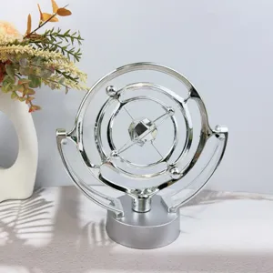 Detailed shot of silver kinetic art celestial globe desk ornament, stylish decor for office.