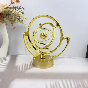 Gold celestial kinetic art perpetual motion desk toy for home office decor and creative gifts.