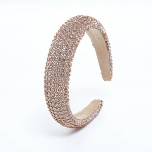 Detailed view of champagne rhinestone padded headband, elegant sparkling hair accessory for women.